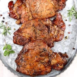 Marinated and grilled pork chops on a platter.