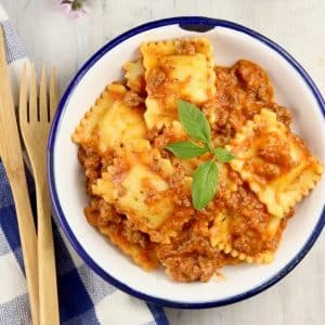 Bowl of ravioli with meat sauce.