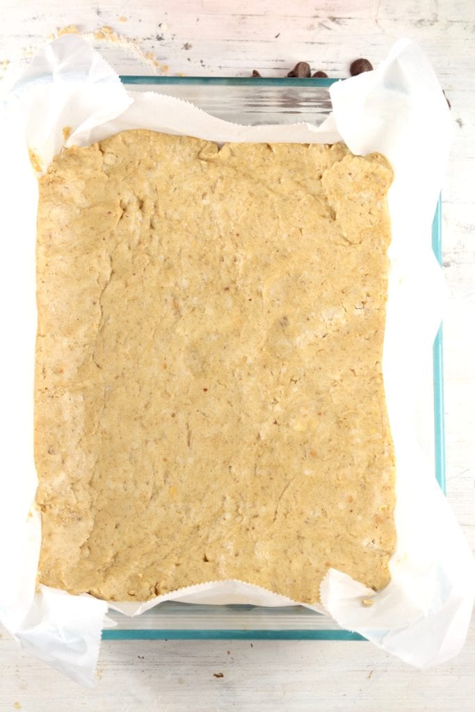 Peanut Butter bars in a parchment paper lined baking dish