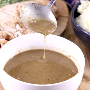 Brown Gravy in bowl with ladle dipping