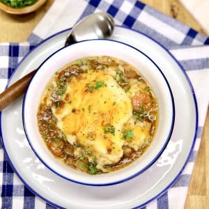 Bowl of cottage pie with cheesy mashed potato topping.