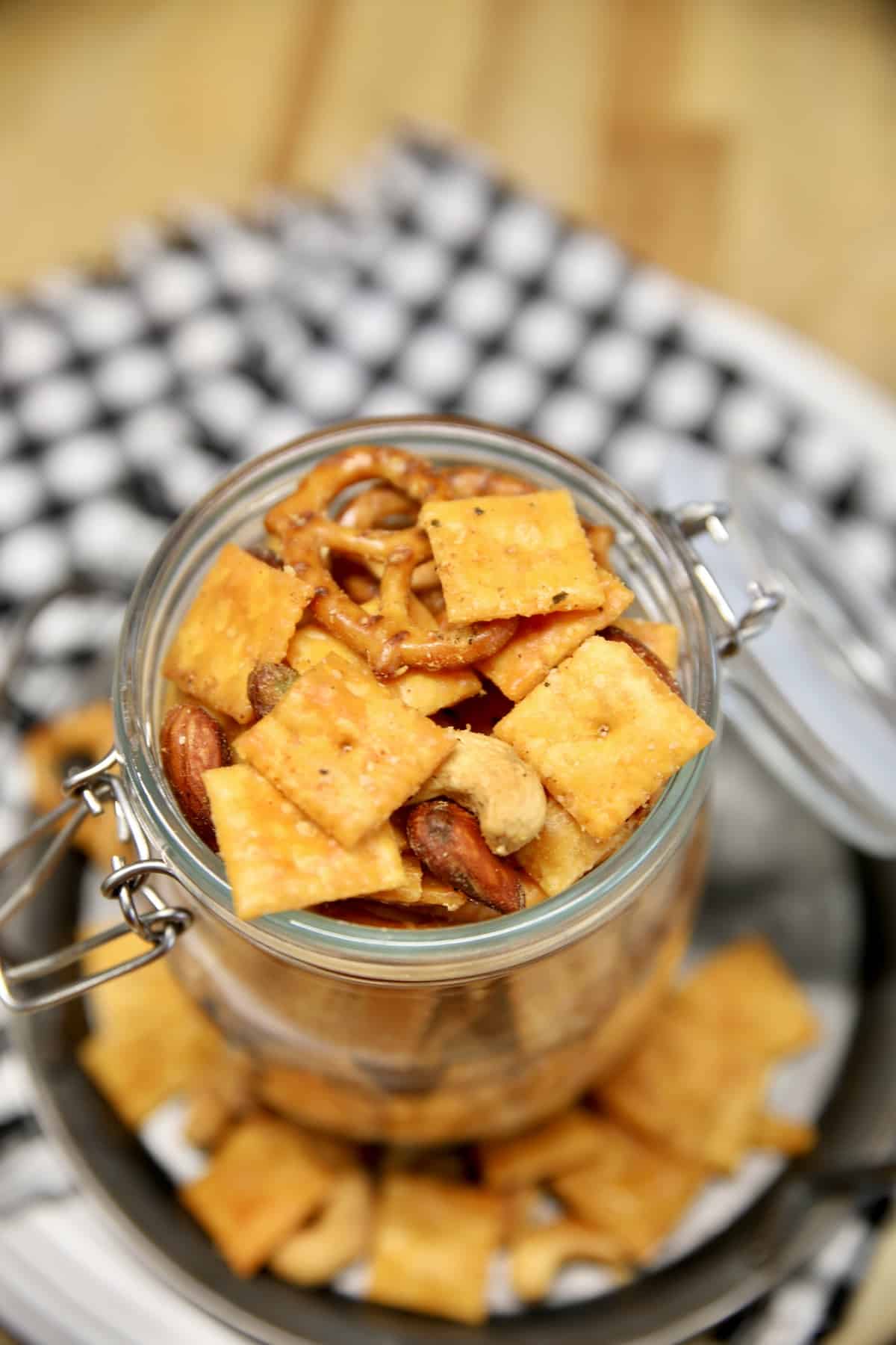 Jar of snack mix with cheese crackers and nuts.