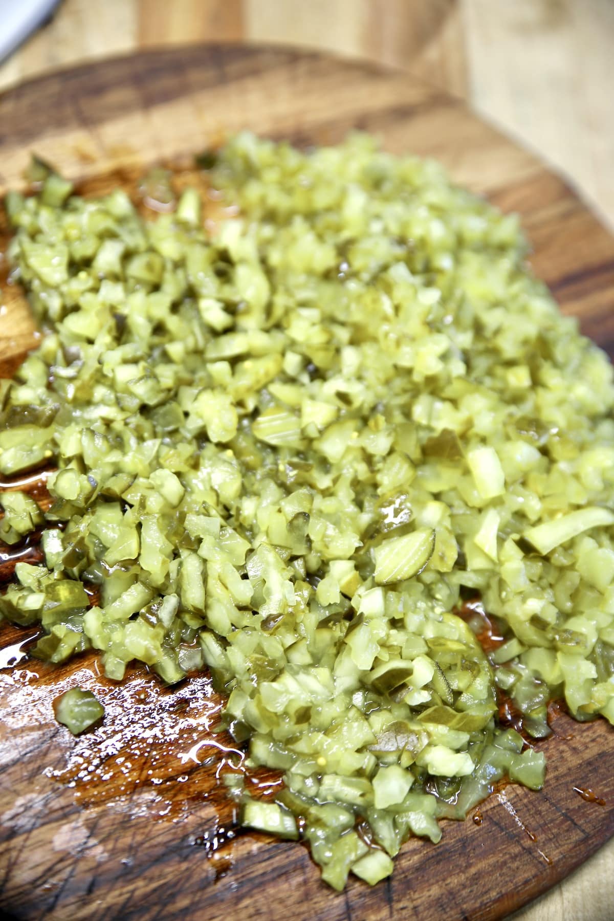 Cutting board with chopped pickles.
