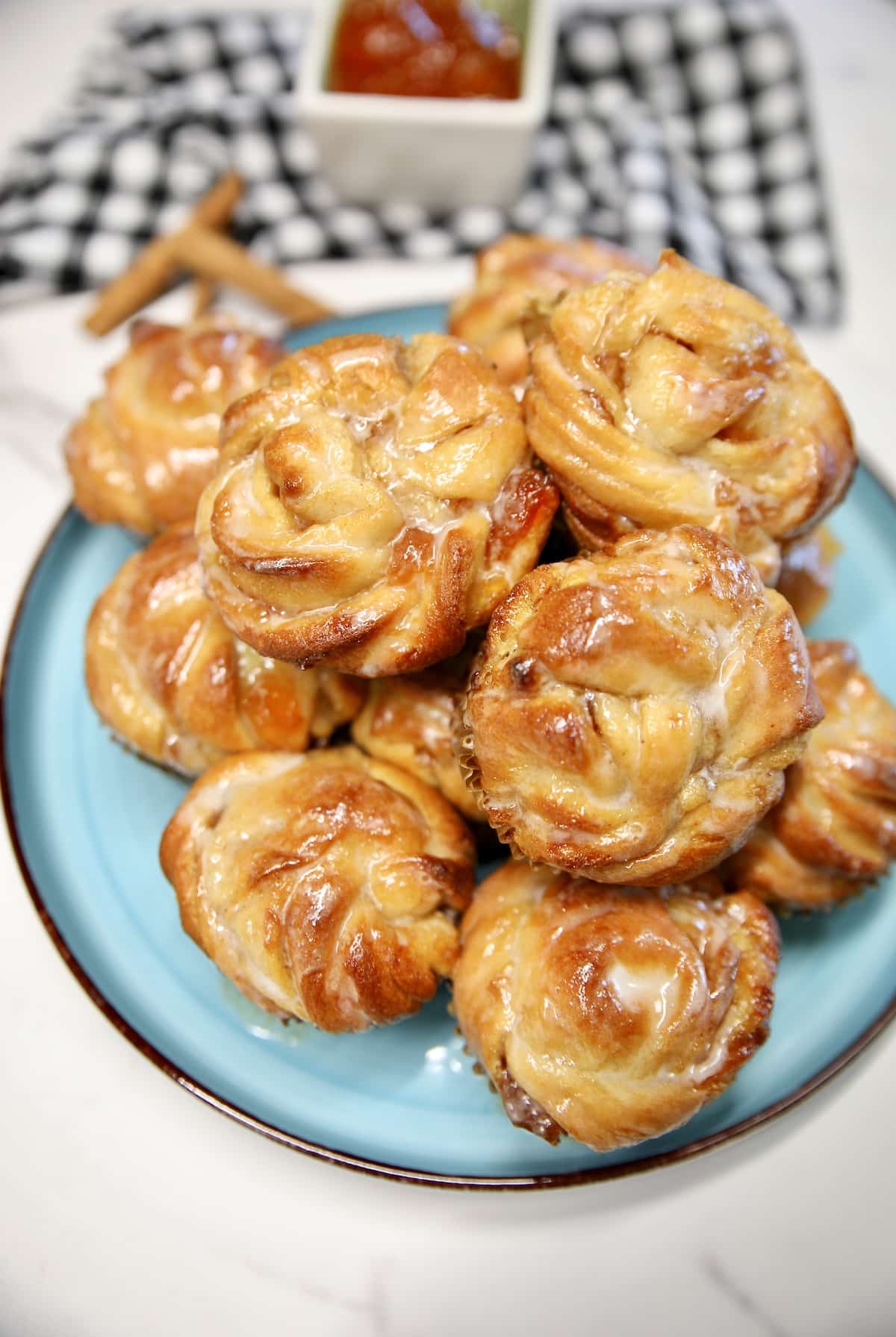 Peach pie cruffins on a plate.