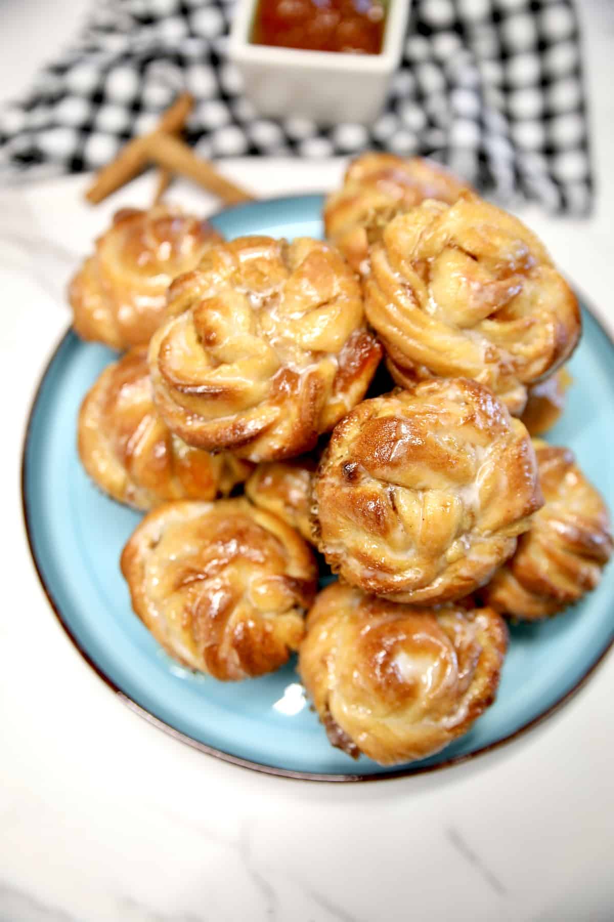 Peach pie cruffins on a plate.