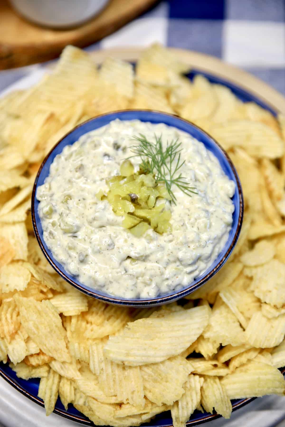 Bowl of pickle dip with potato chips.
