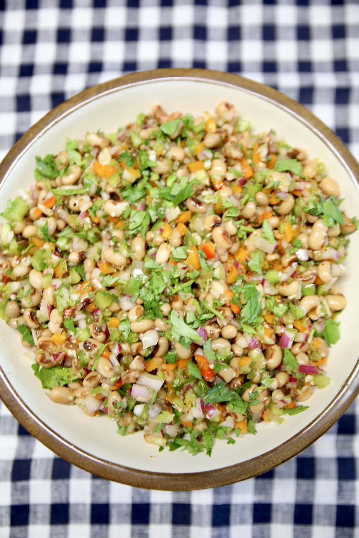 Black eyed pea salad on a checked cloth.