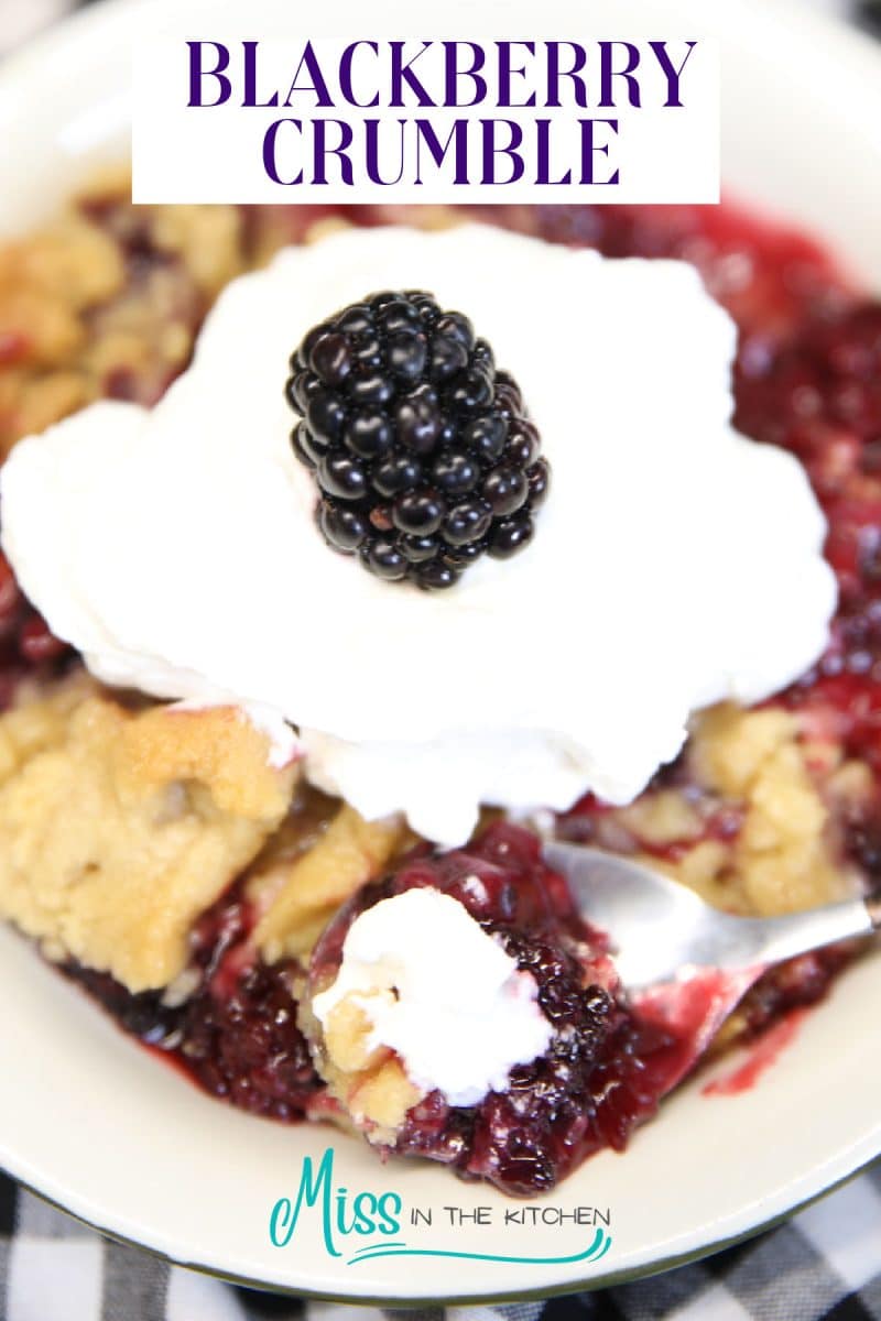 Blackberry crumble with whipped cream, text overlay.