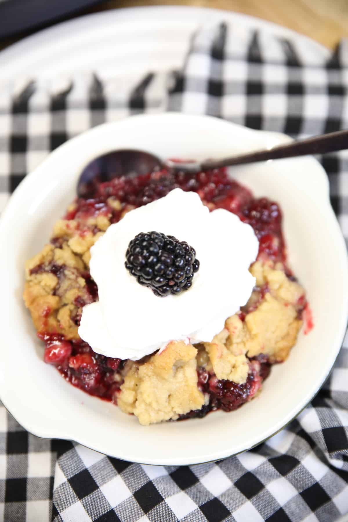 Blackberry Crumble dessert in a bowl with spoon.