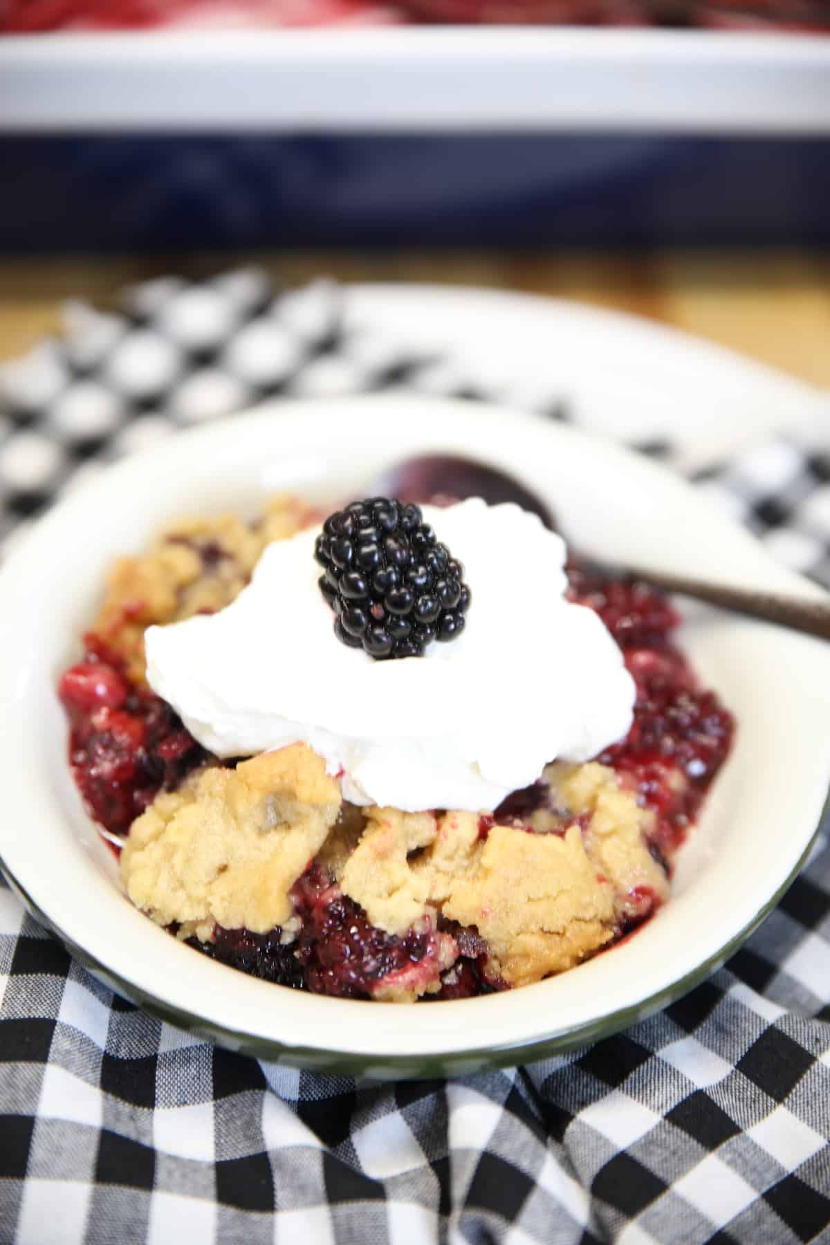 Blackberry Crumble in a bowl with whipped cream.