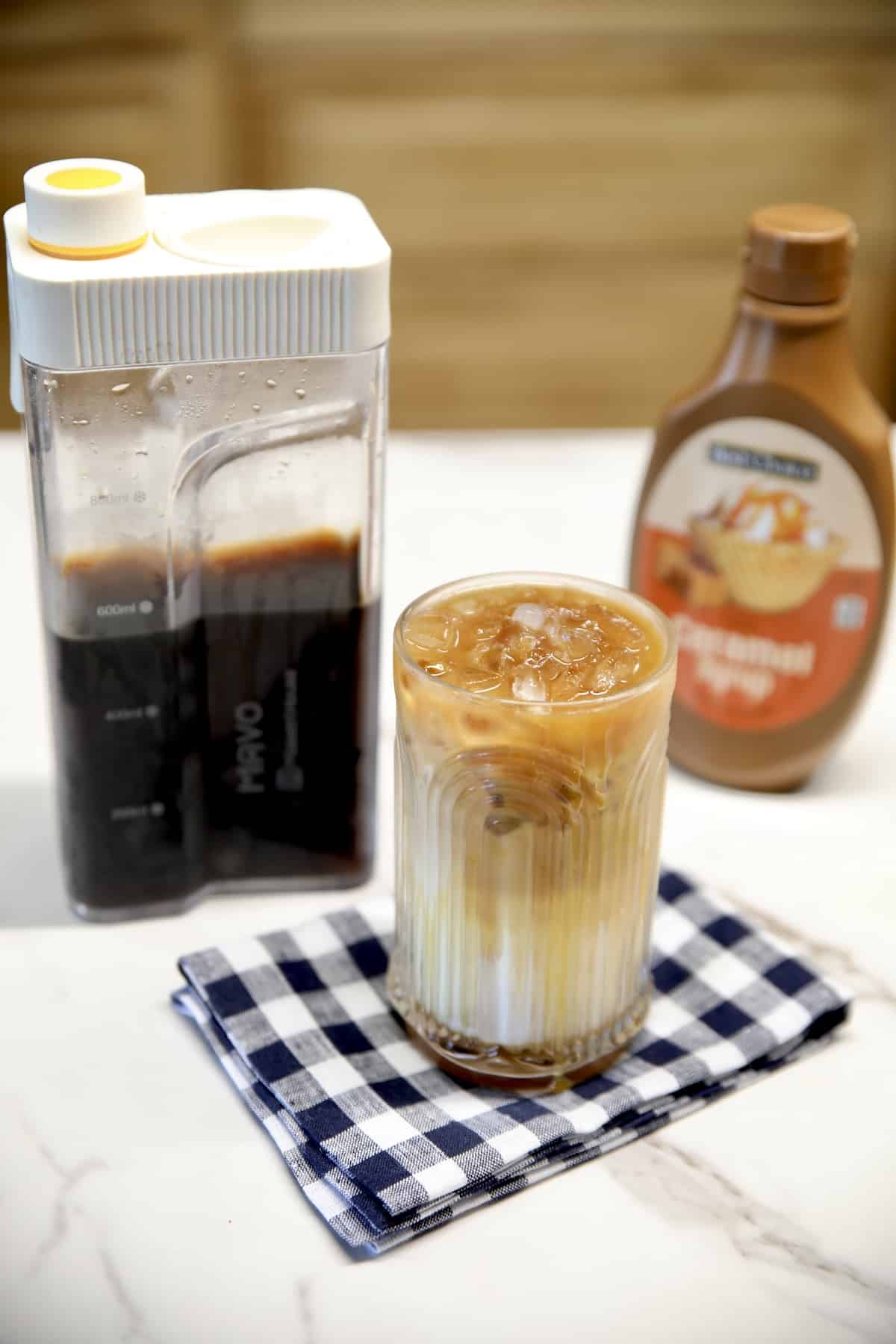 Cold brew coffee with caramel sauce and caramel macchiato in a glass.