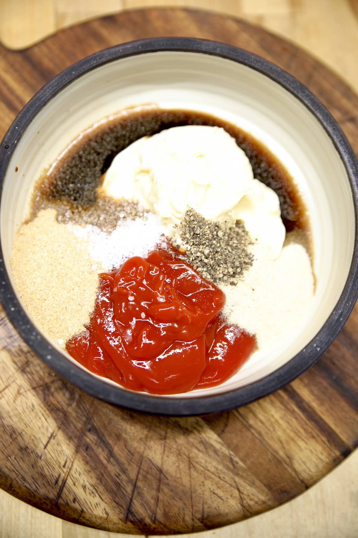 Bowl of ketchup and mayo, seasonings for fry sauce.