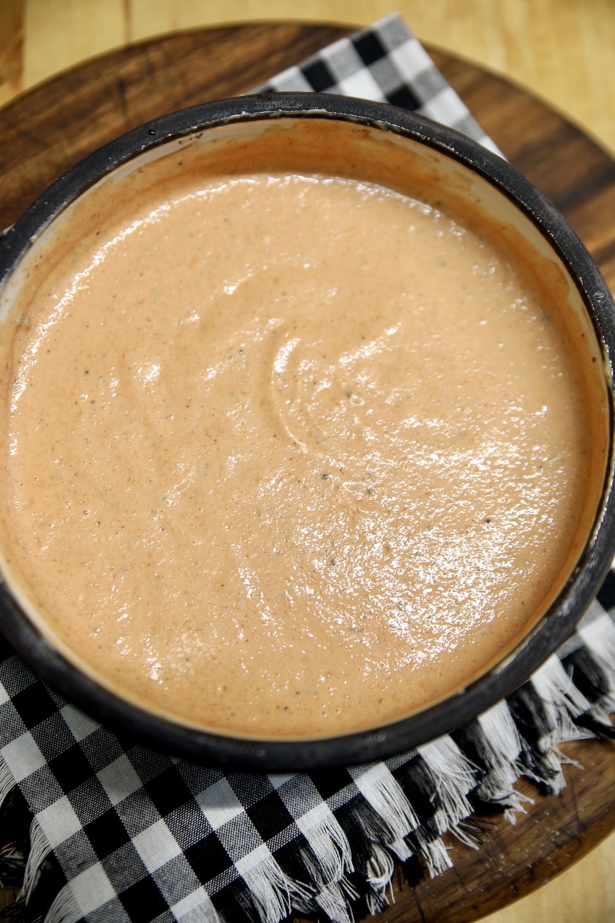 Fry sauce in a bowl on a check napkin.