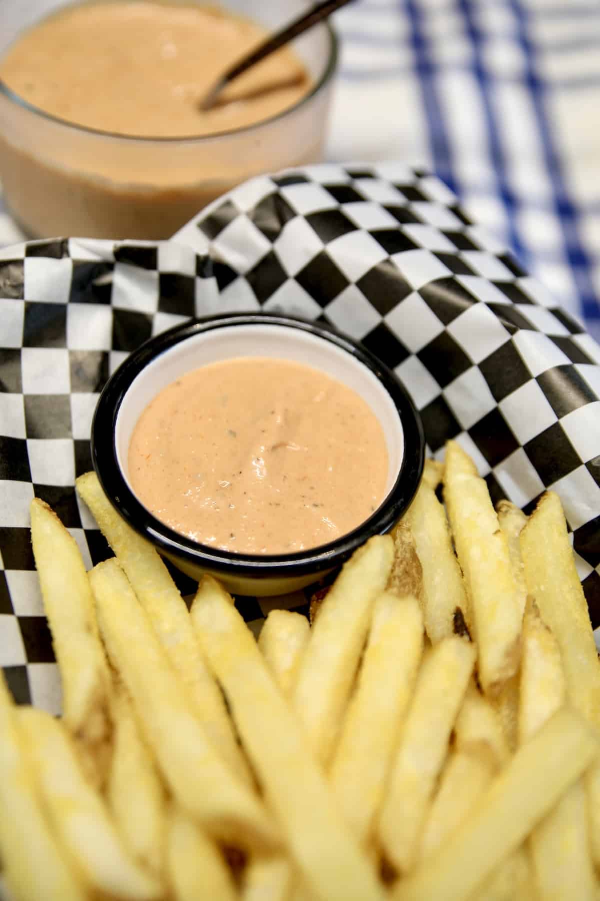 Fry sauce in a basket of french fries.