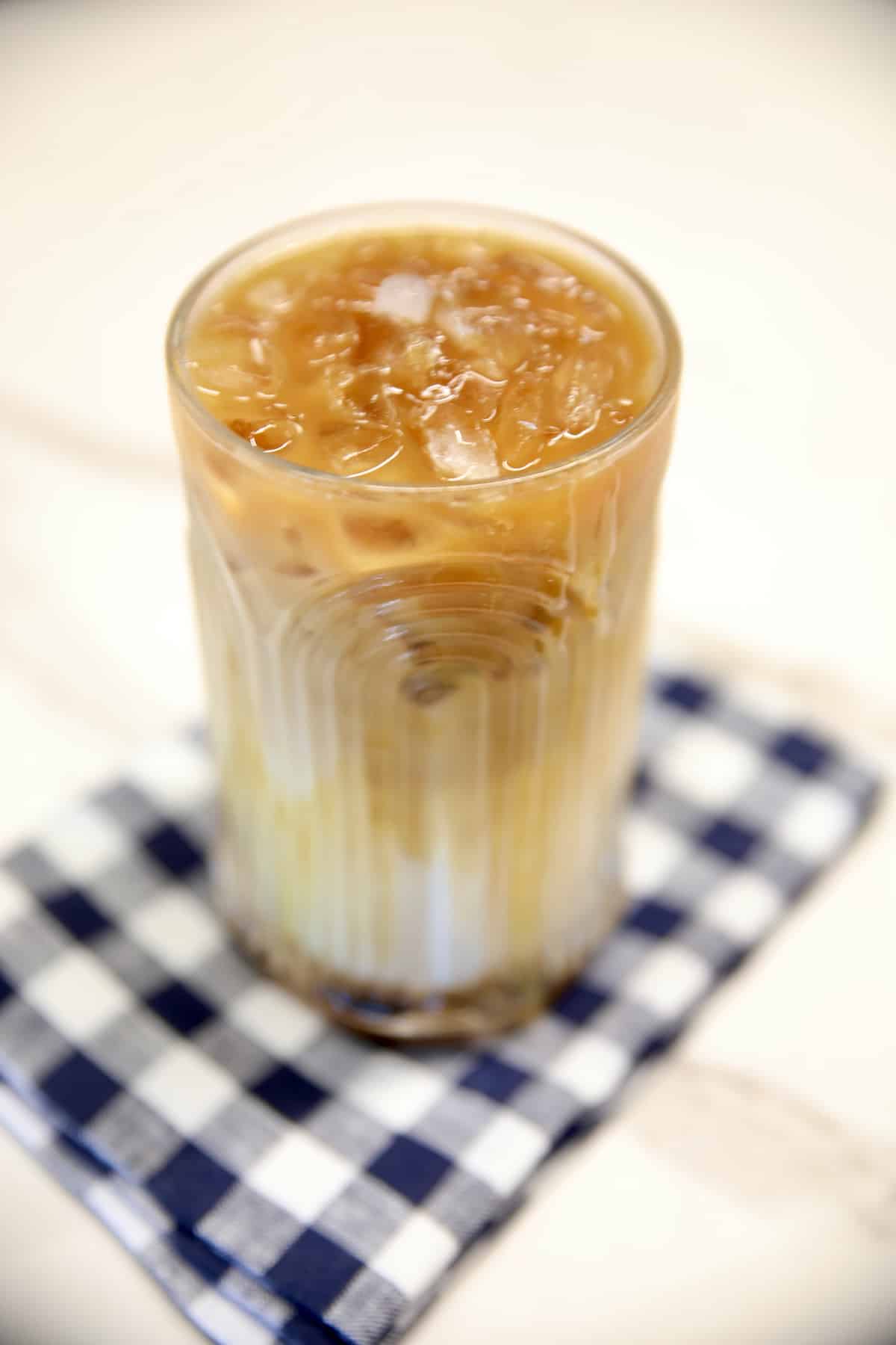 Caramel Macchiato with ice in a glass on a napkin.,