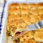 Ham, pineapple and cheese sliders on a spatula.