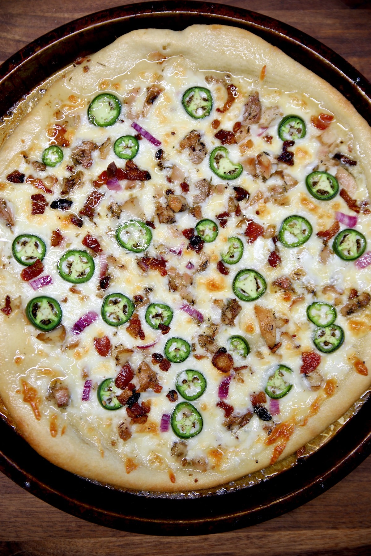 Chicken bacon ranch pizza with jalapenos.