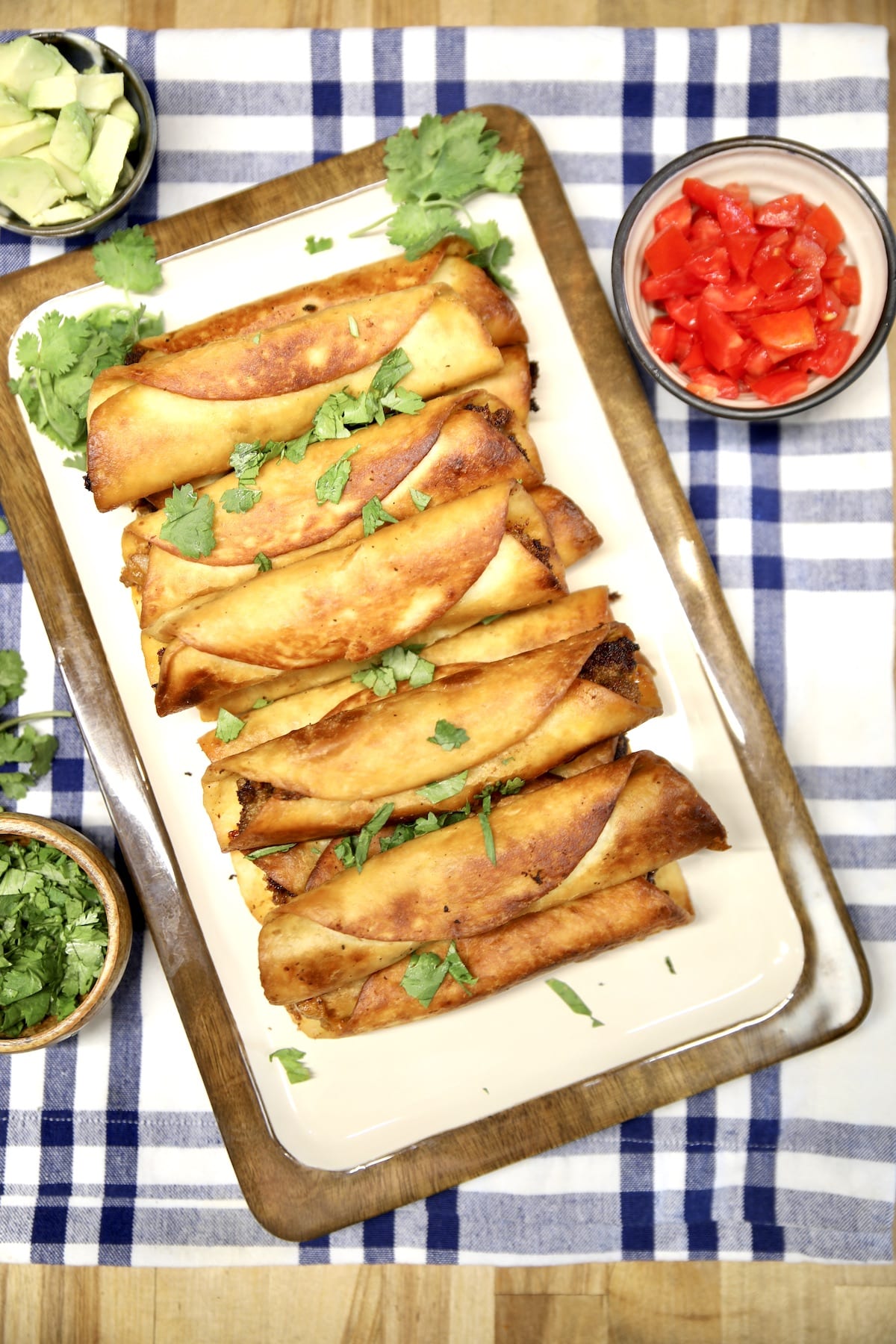 Taquitos with tomatoes and avocado.