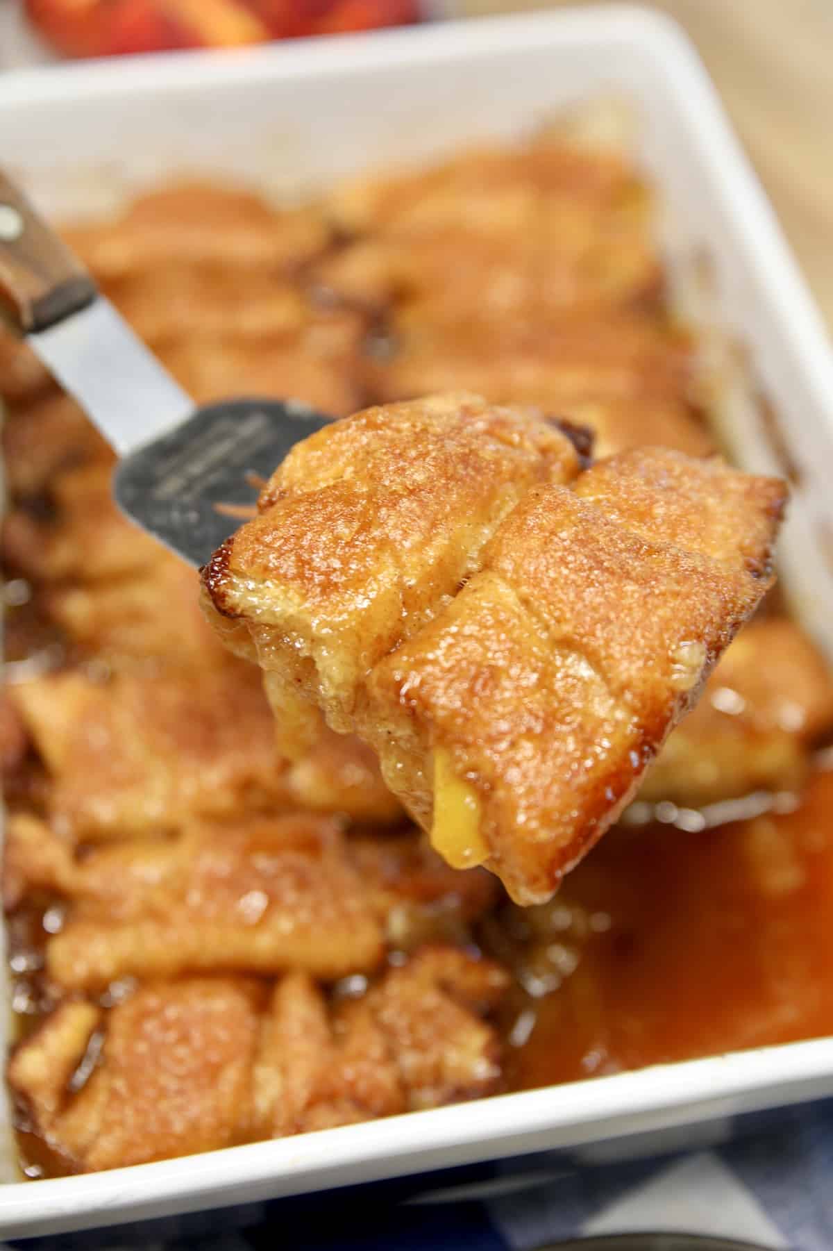 Peach dumplings on a spatula.