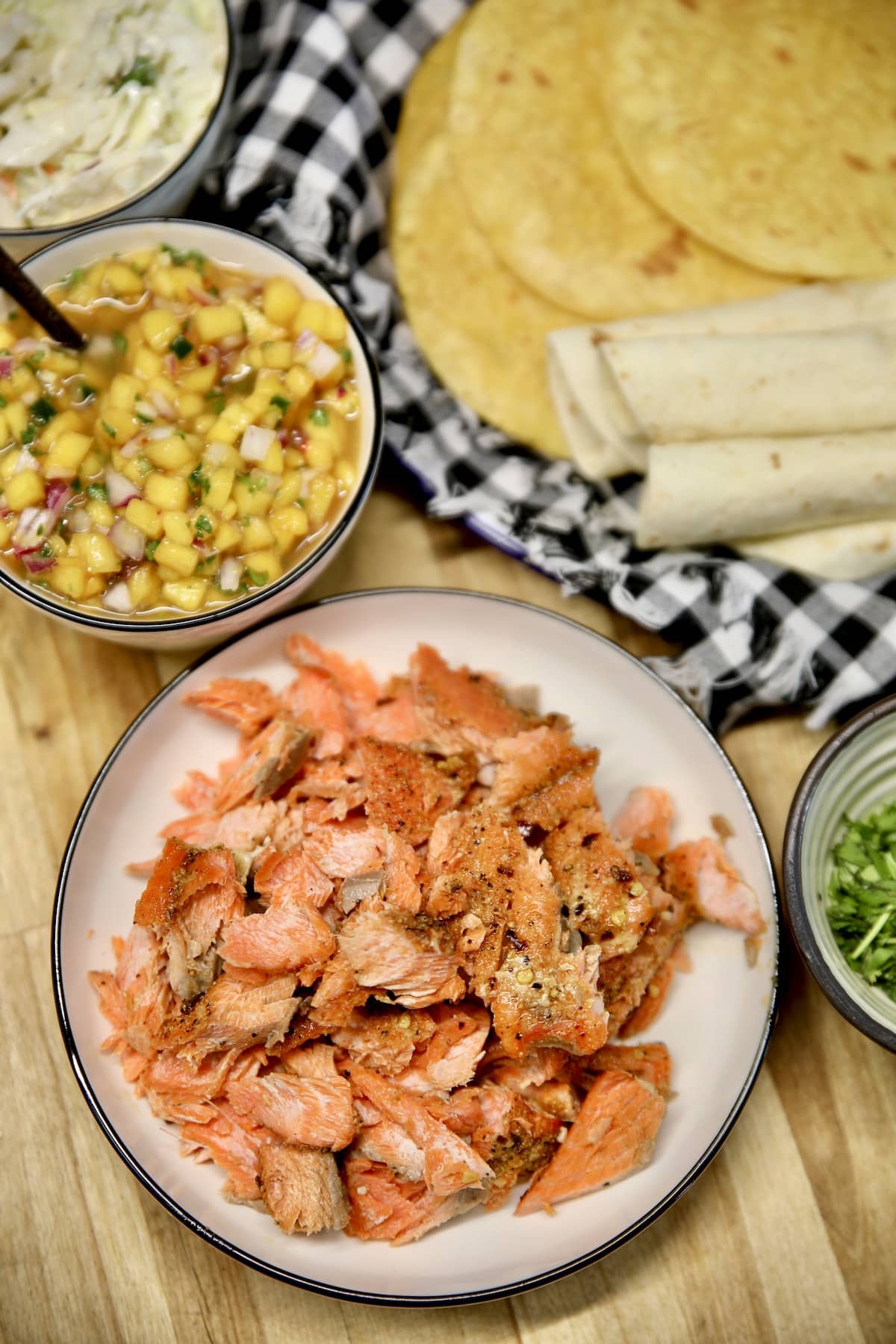 Platter of salmon chunks, tortillas, salsa.