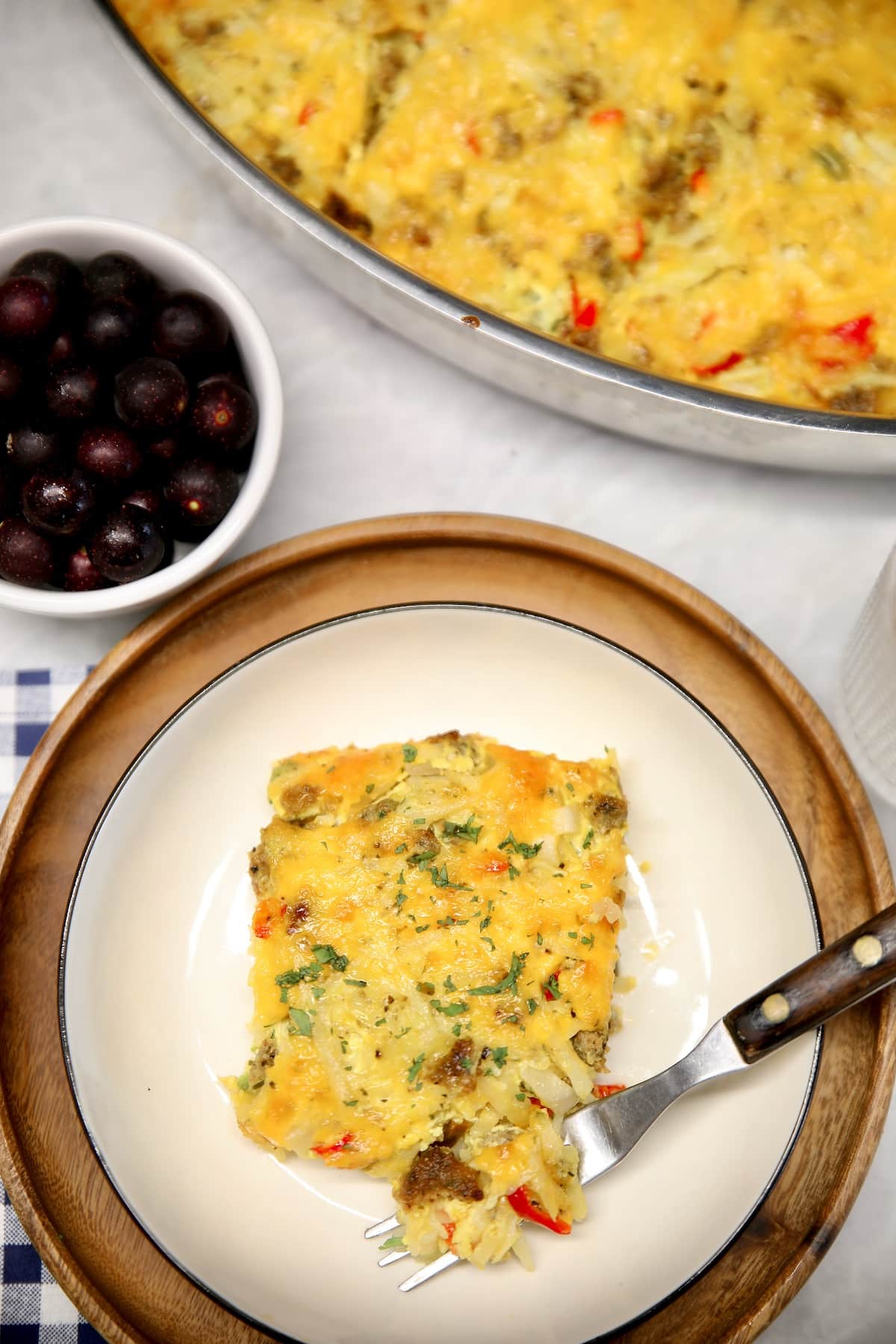 Hashbrown casserole with sausage and cheese on a plate. 