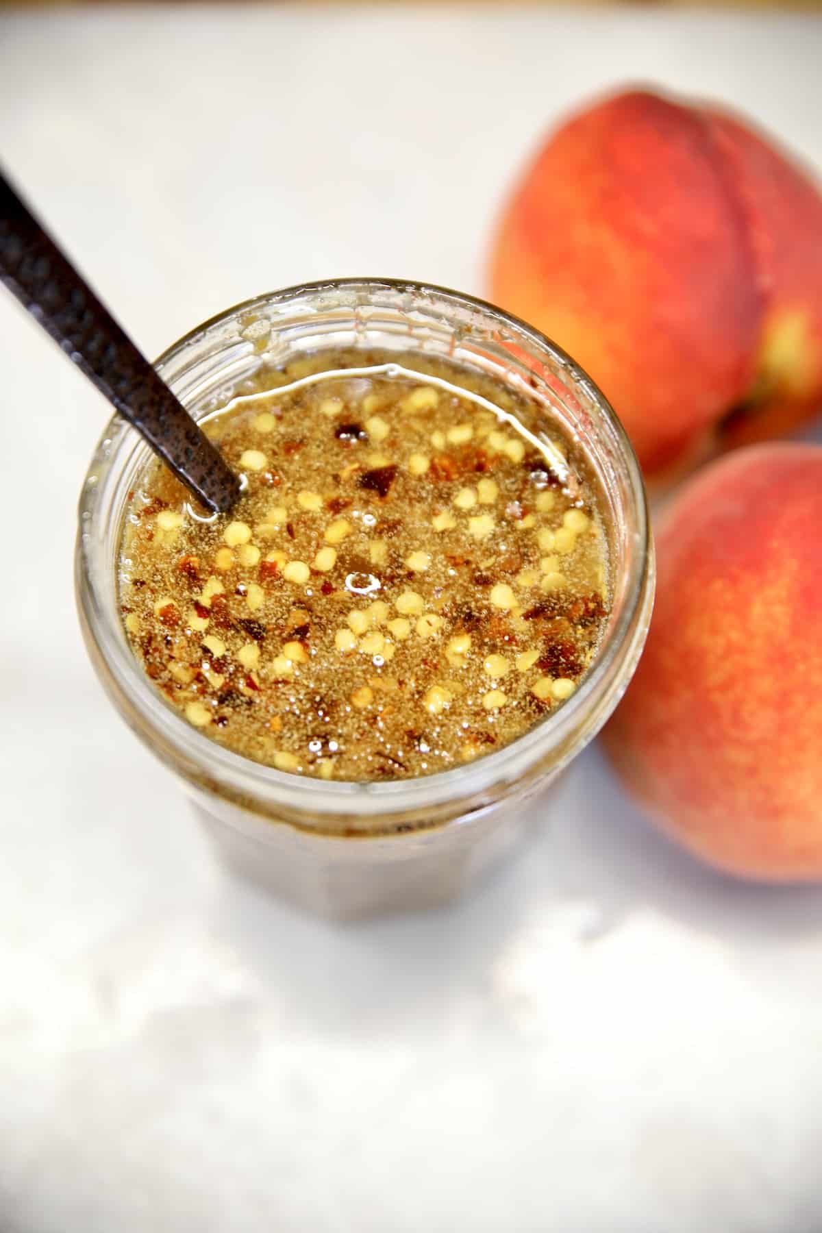 Jar of hot honey with peaches.