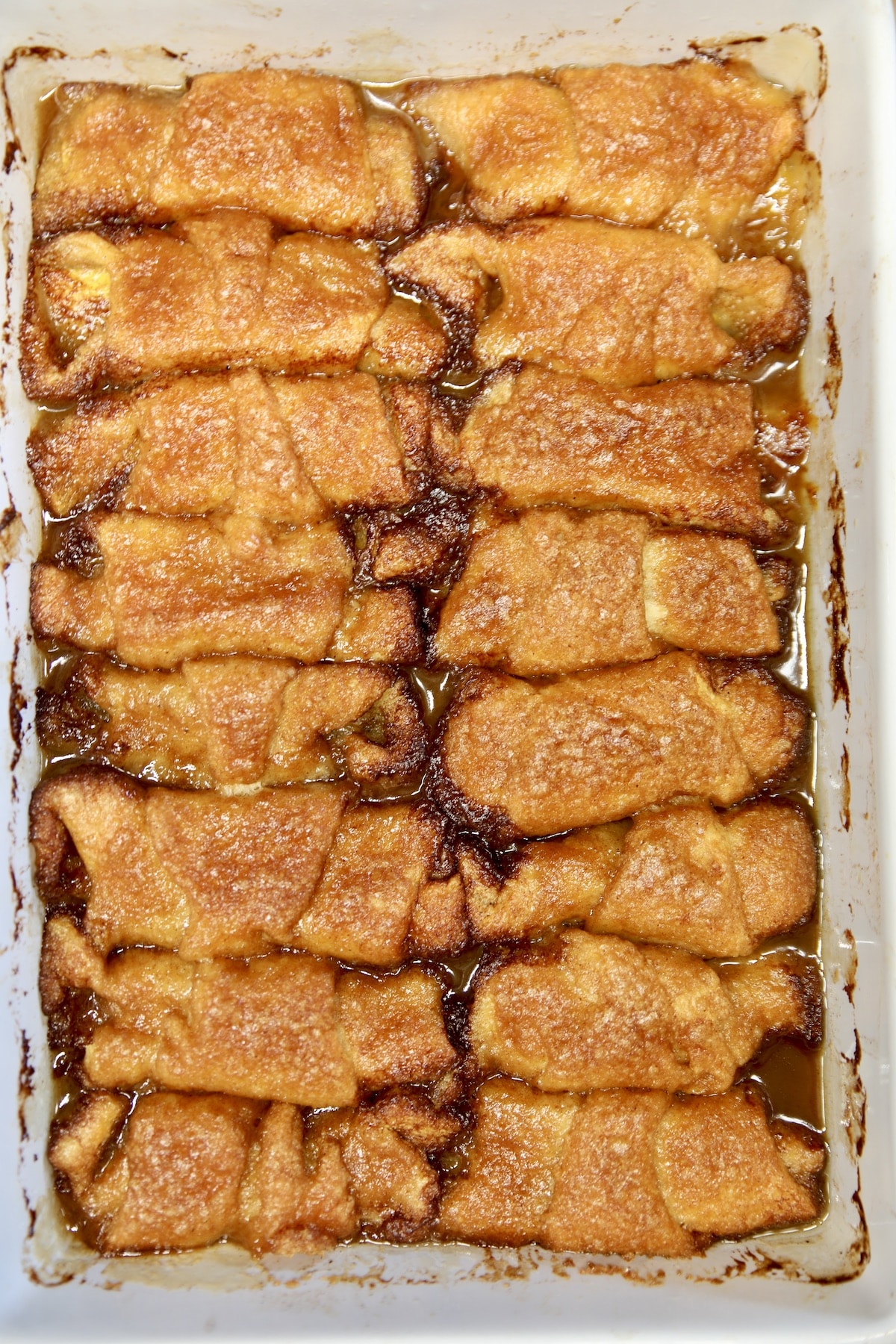 Baked peach dumplings in a pan.