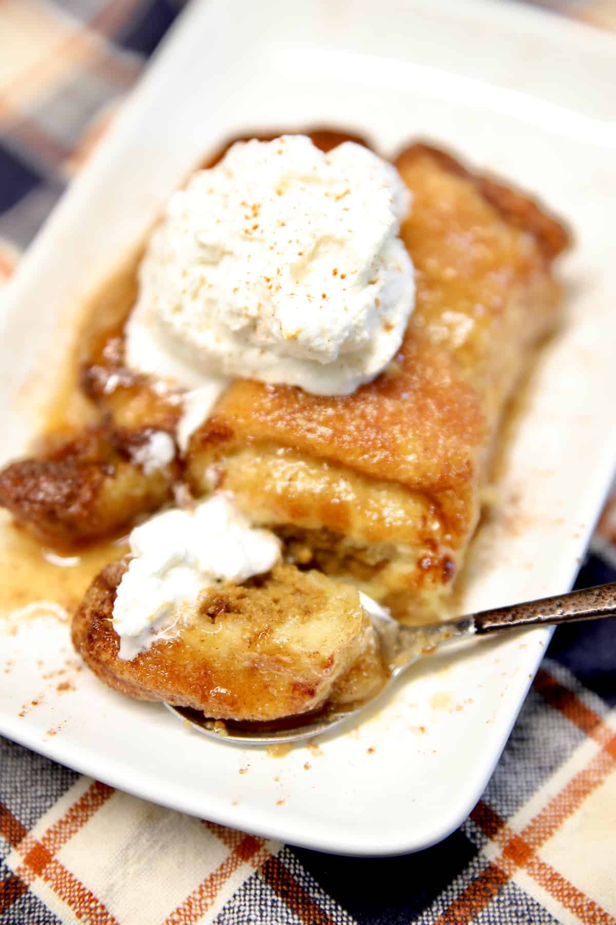 Pumpkin dumpling with whipped cream on a plate.