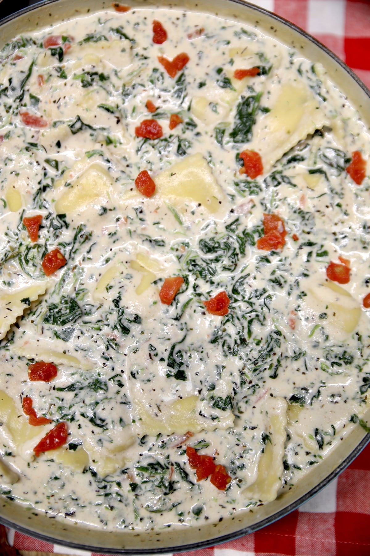 Tuscan ravioli with spinach and tomatoes.