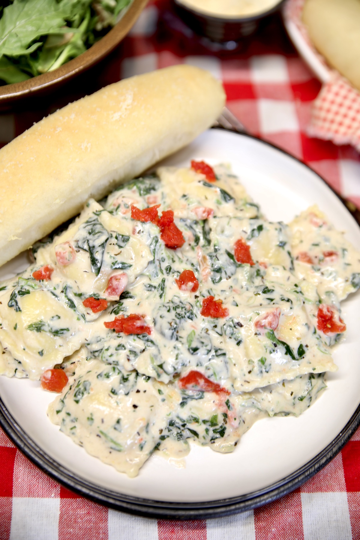 Bowl of ravioli and a breadstick.