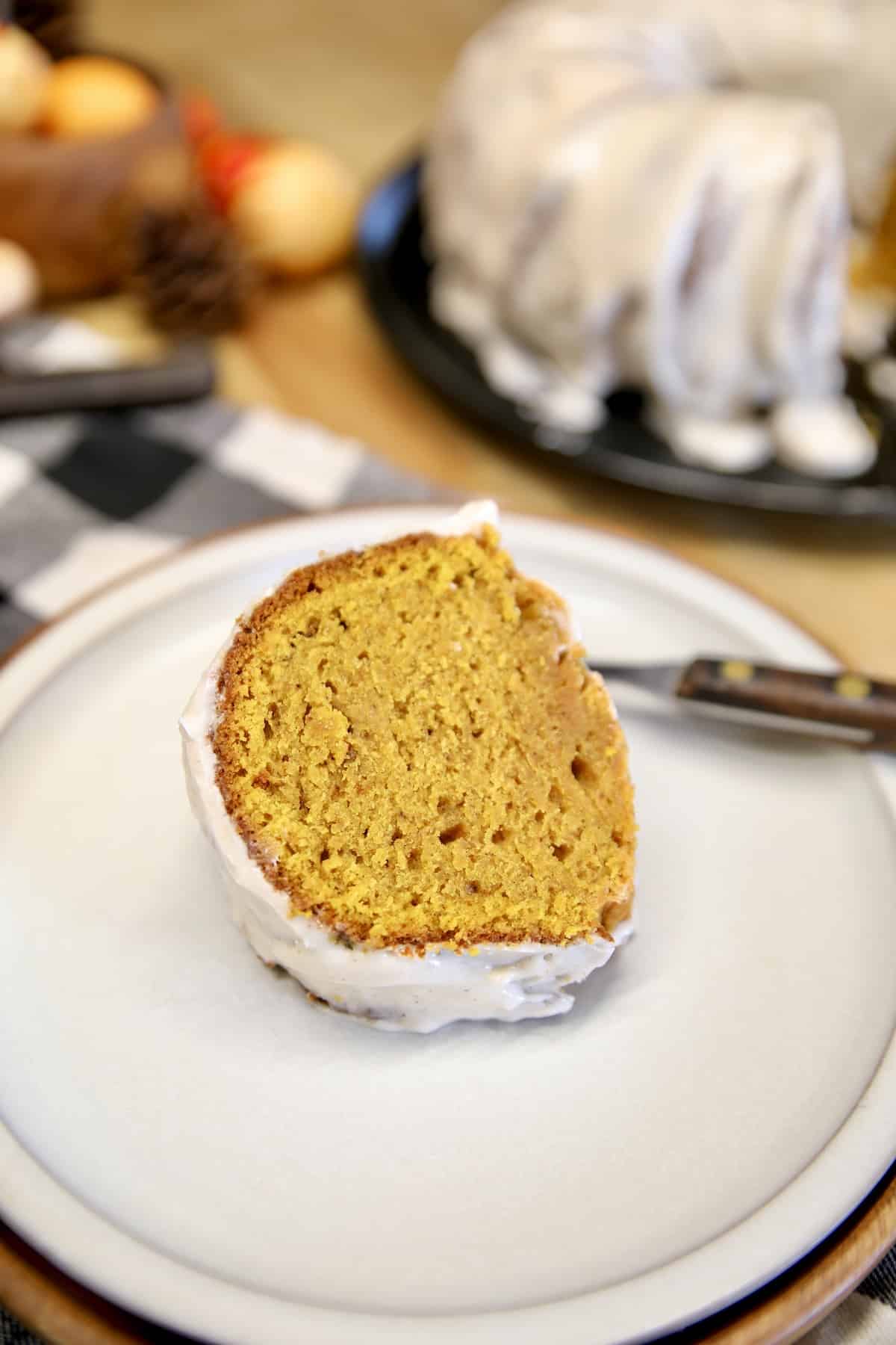 Pumpkin bundt cake slice on a plate.