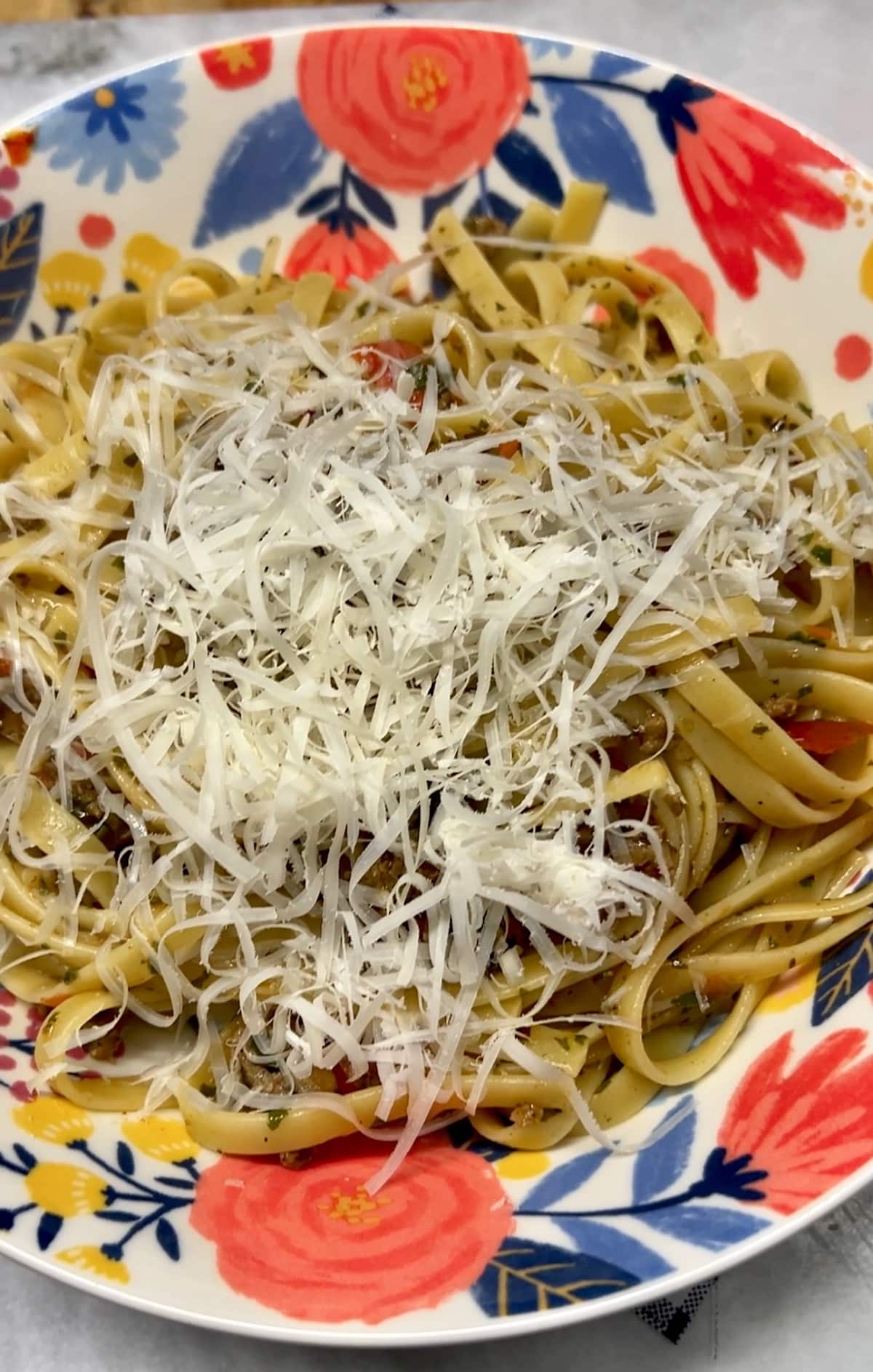 Pasta with parmesan cheese in a bowl.