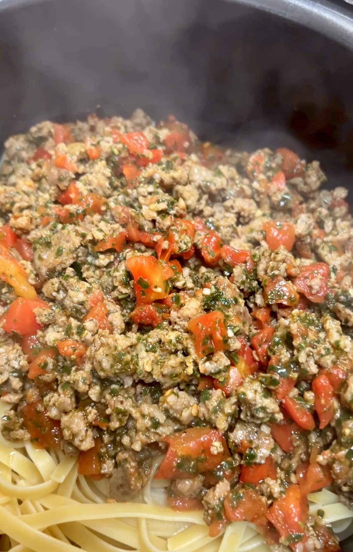 Sausage and fettuccine with tomatoes in a pan.Sausage Fettuccine is a super simple weeknight dinner with just a few ingredients that can be on the dinner table in under 30 minutes. It's a great option for nights you don't know what to cook.