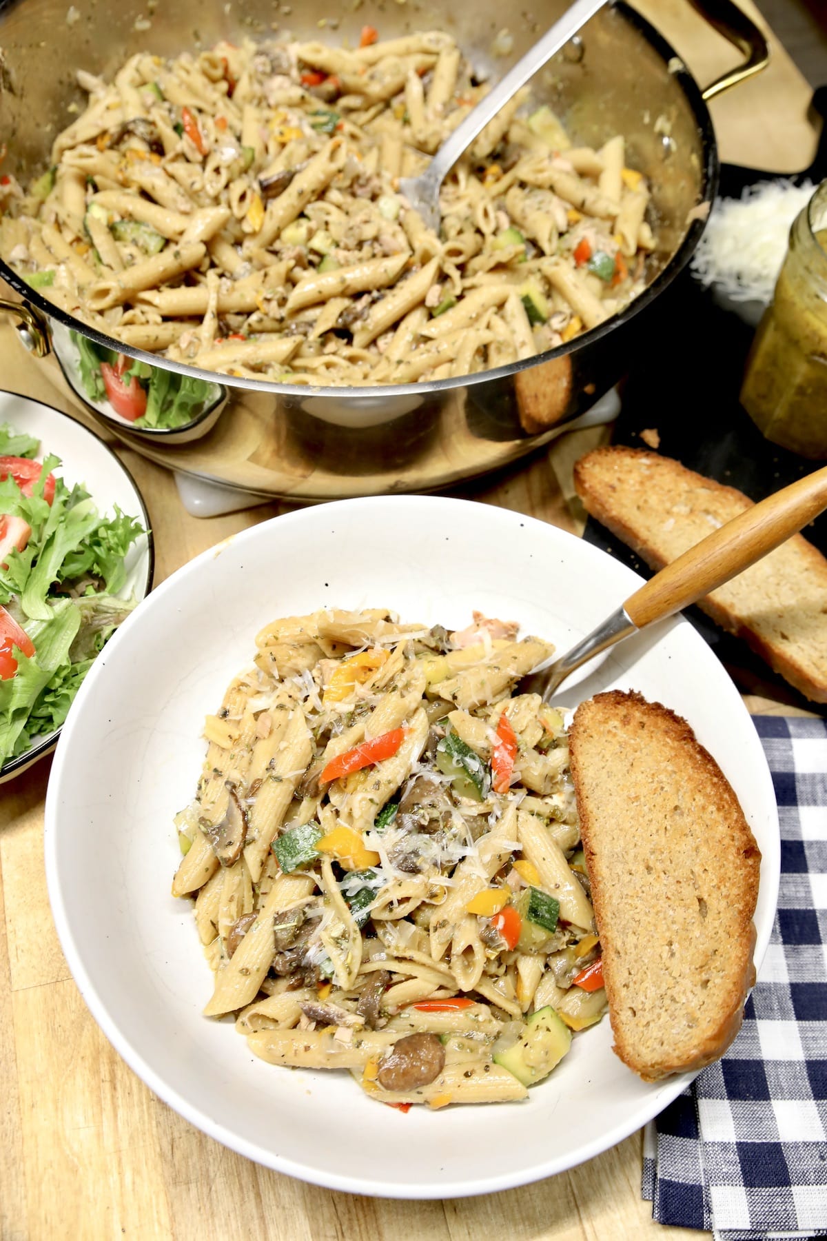 Pasta in a bowl with toasted wheat bread.