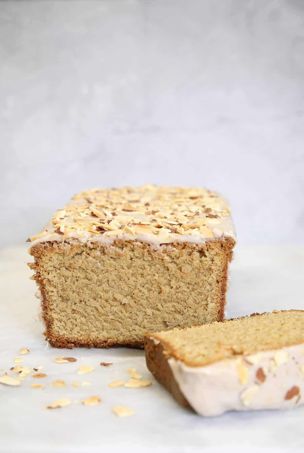 Cinnamon pound cake loaf, one slice in front of loaf.