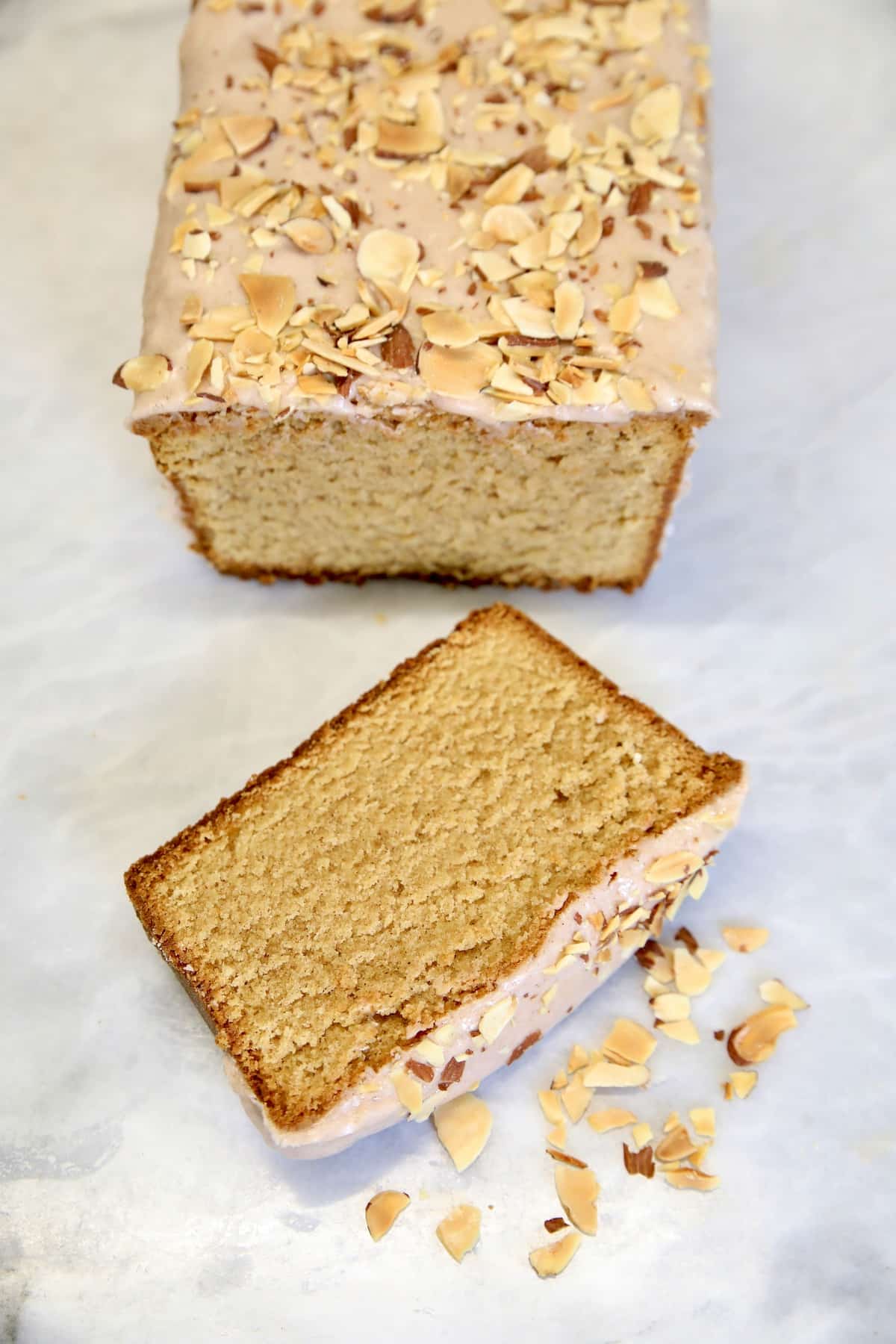 Cinnamon pound cake loaf with one slice.