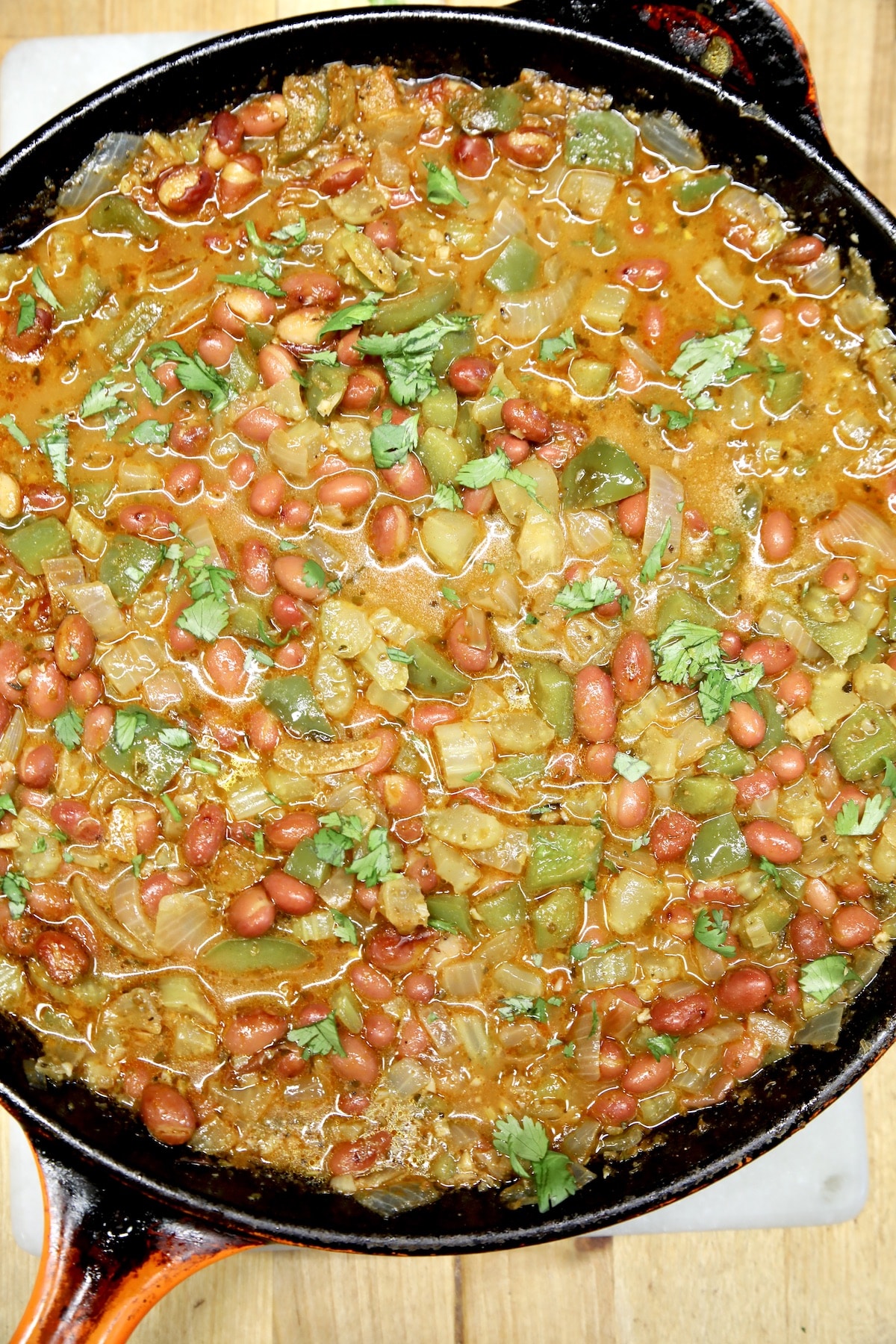 Skillet of red beans with vegetables.