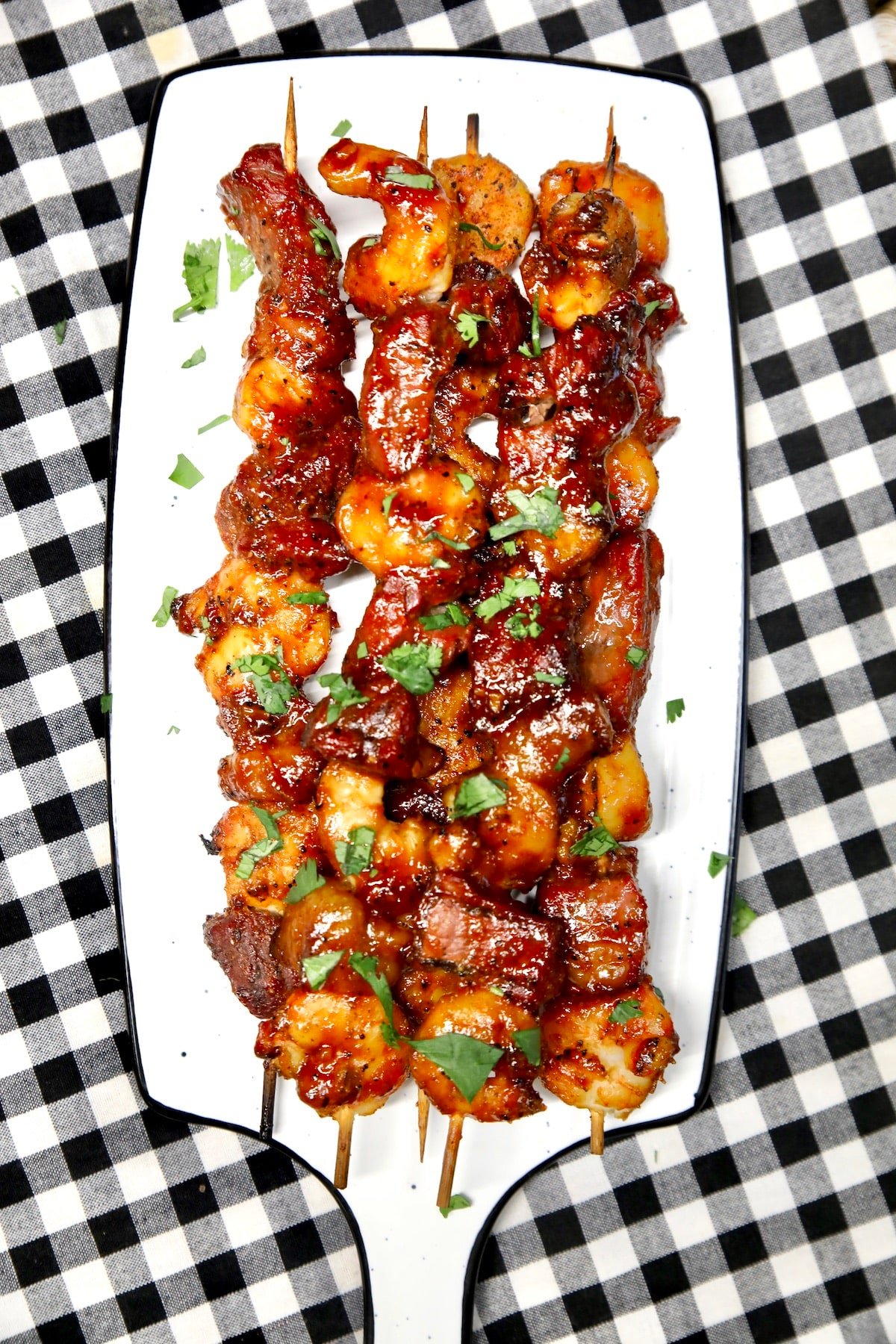 Platter of bbq steak and shrimp skewers for party appetizer.