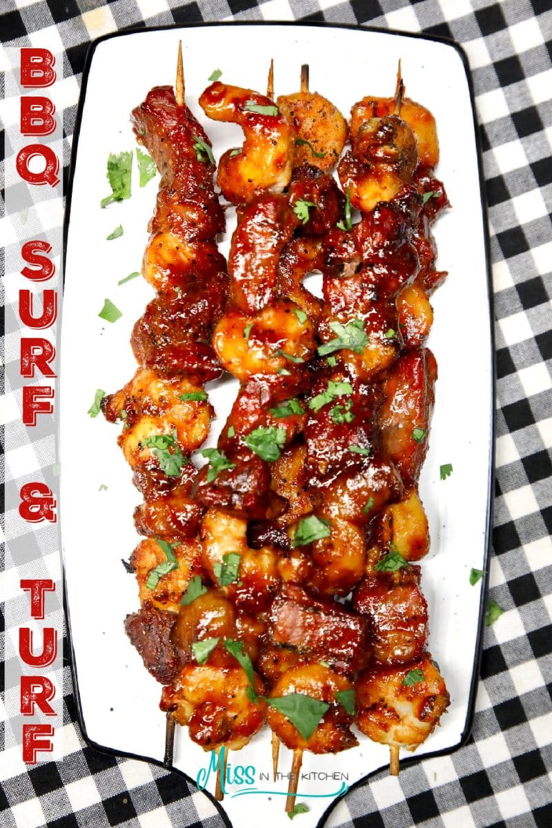 BBQ Surf and Turf skewers with bbq sauce on a platter.