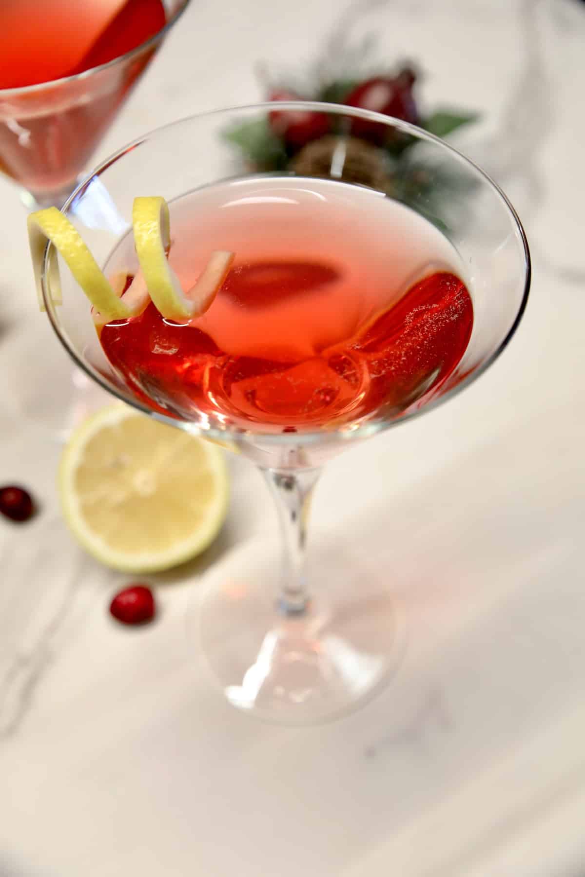 Cranberry martini with lemon twist.