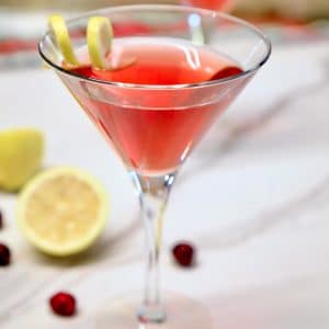 Cranberry Martini in a glass with lemon twist.