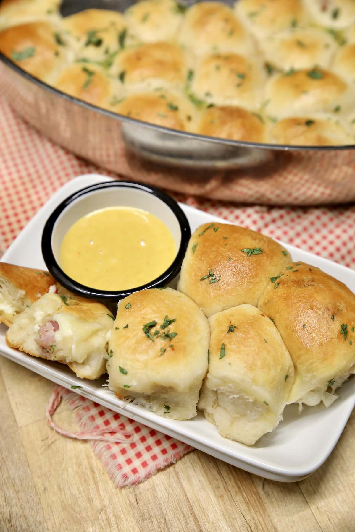 Small plate with ham biscuits and honey mustard.