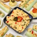 Jalapeno cheese spread in a bowl with stuffed celery.