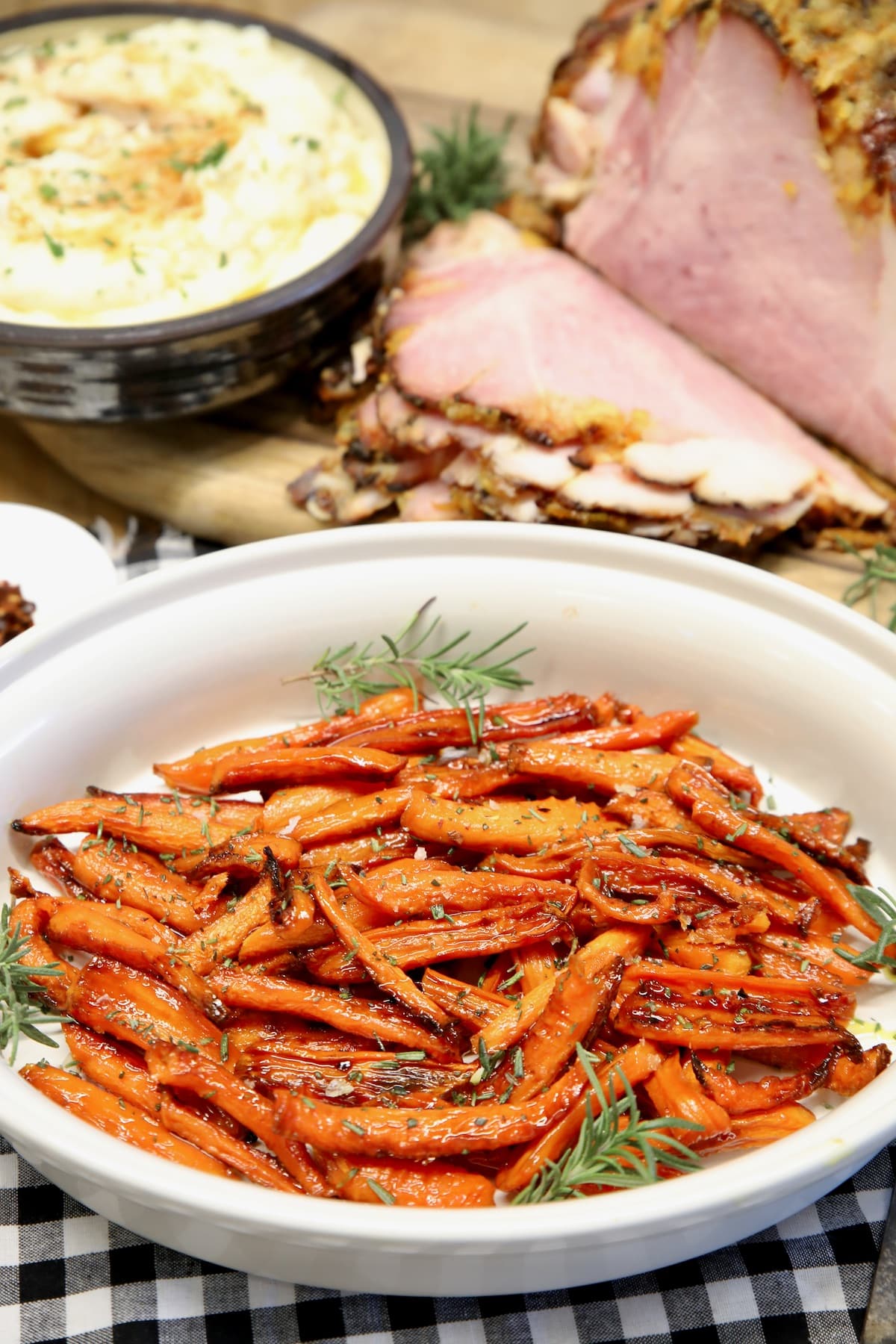 Platter of glazed carrots, mashed potatoes and ham.