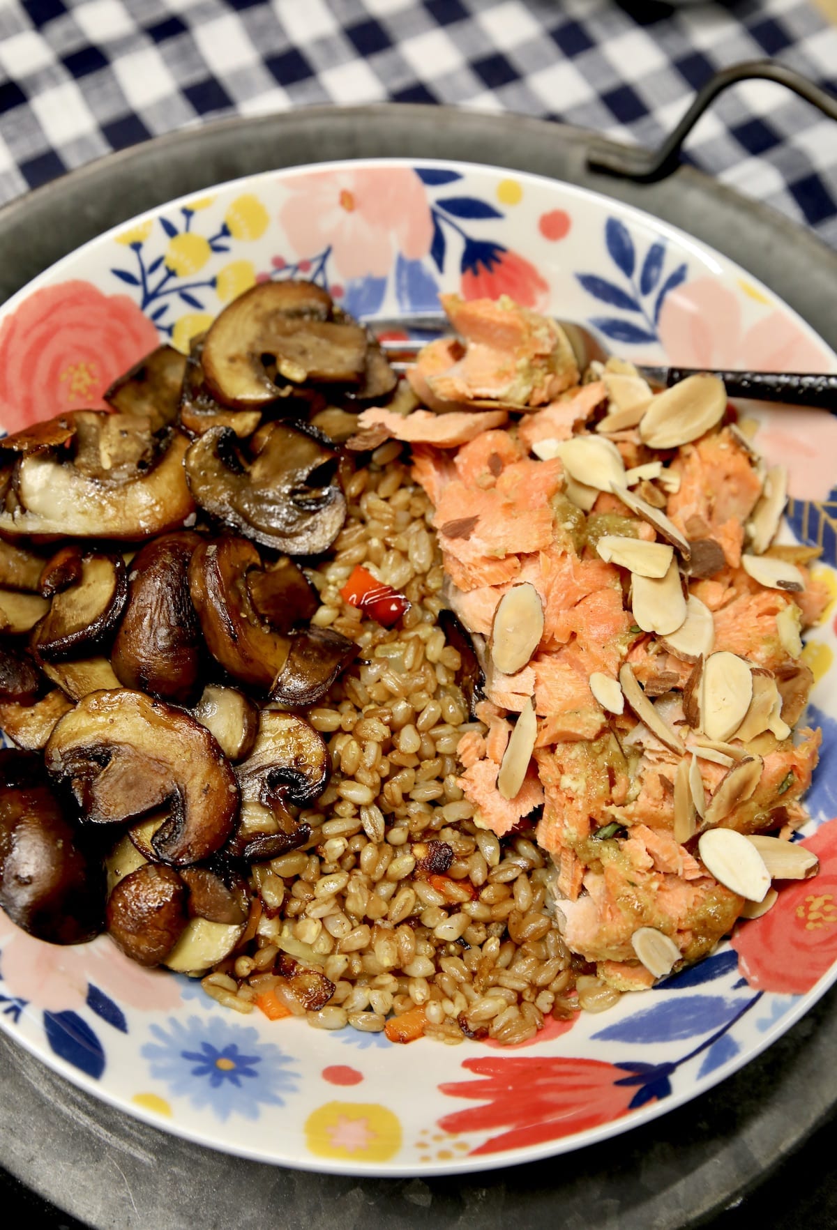 Dinner bowl with salmon, farro and mushrooms.