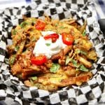 Loaded pulled pork fries with sour cream and jalapenos.