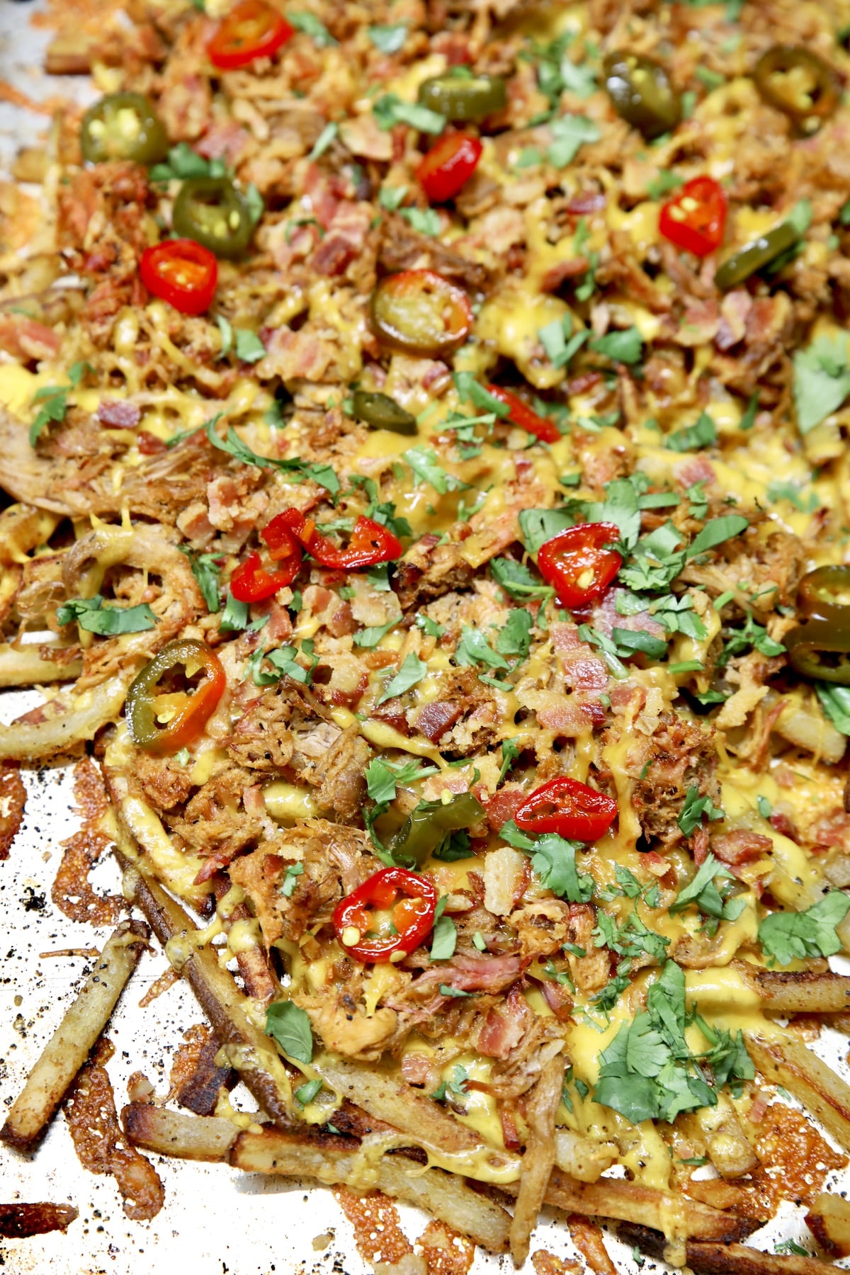 Sheet pan pulled pork fries with jalapenos.