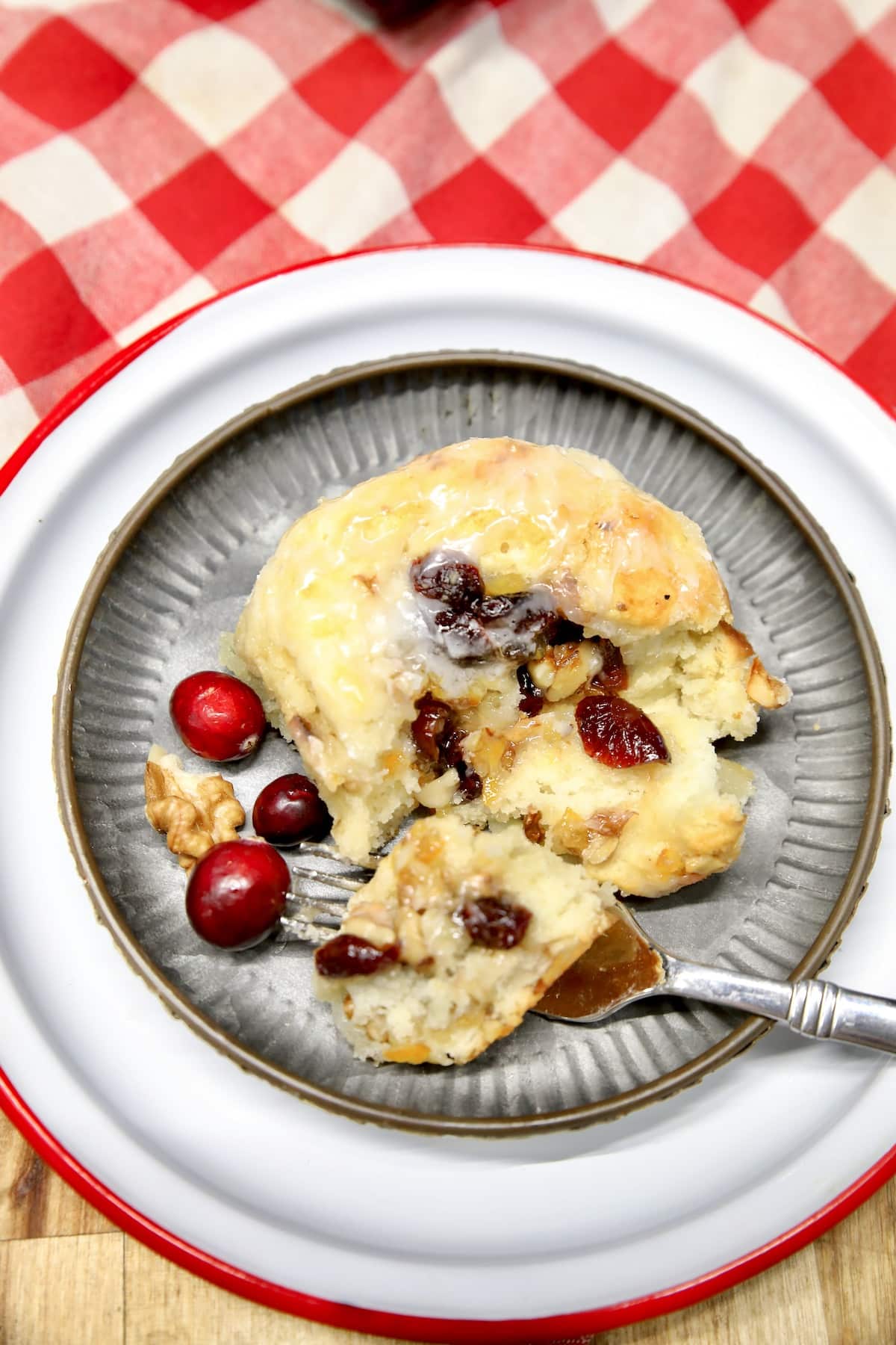 Sweet roll with cranberry and orange filling on a plate with fork.