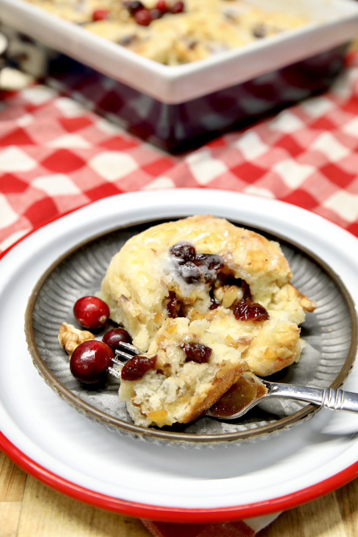 Plate of orange cranberry sweet roll.